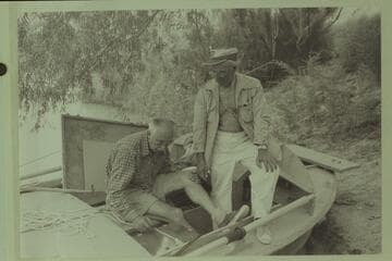 Masland and Marston study a lashing for the sound machine.  The boat is the "Bootoo."  Lees Ferry