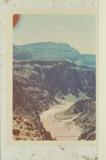 The Suspension Bridge and the mouth of Bright Angel Creek with the flow of the river muddied from the Little Colorado
