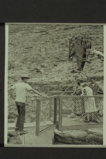 Marion Hudson prepares to step out of the skip while Margaret Marston picks up her bags.  The ledge camp of the USBR