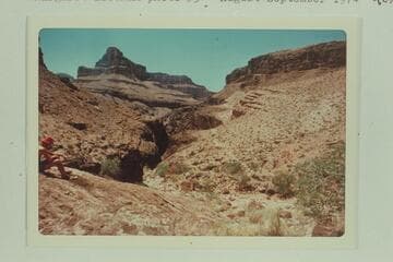 From Bass Asbestos Mine in Hakatai Canyon looking across and down this canyon. A trail appears on right bank. There were many burros in the area