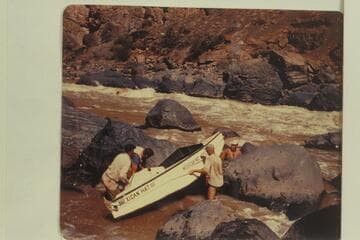 Lining of the "Mexican Hat III"--or is it a portage?  Frank Wright; John Harper; Bill Thompson; Willard Wright.  No life preserver protection for the leader and others.  Georgie White ran her party through the rapid at this same time