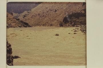 Larry Sanderson running the "Cactus" out from the rough water of Vulcan Rapid