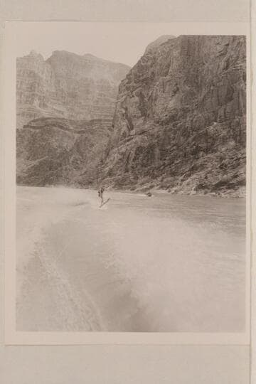 Cooper skiing on upper Lake Mead in Grand Canyon. The "June Bug" is in the distance