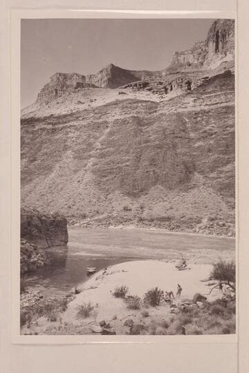 The motorboat "Hudson" in the lagoon and the helicopter on the beach at the mouth of Tapeats Creek in the Grand Canyon.  Camp groups include:  Margaret Marston, "Red" Carson, Joe Desloge, Willie Taylor, Bill Belknap and Guy Forcier