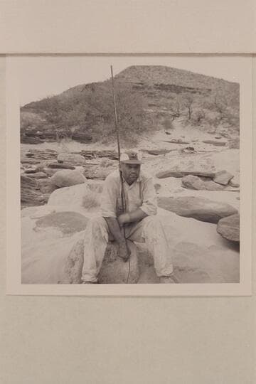 Les Gear holds the aerial for radio at Unkar Rapid