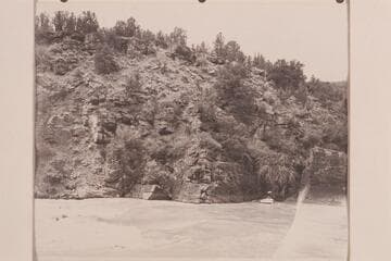Head of Ashley Falls in Red Canyon.  Nevills and Frost are in the boat which has been rowed across to the head of the rapid in preparation for lining
