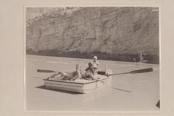 Nevills at the oars of the "WEN" at the foot of Horseshoe Canyon. Joan Nevills and Ros Johnson are on the stern and Al Milotte sits foreword. Note the "windmill recovery" of the oars used by Nevills