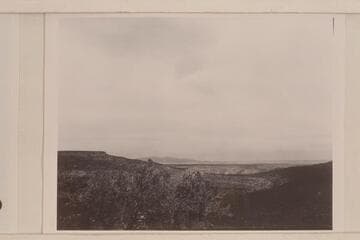 View into Mule Canyon from escarpment on the Shivwits Plateau. The table land on the left is the end of Grassy Mountain. In the distance, center is Mt. Emma. The Grand Canyon is to the right and out of the picture
