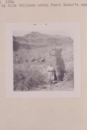 Pearl Baker at the chimney which was part of Cass Hite's cabin at Ticaboo Creek