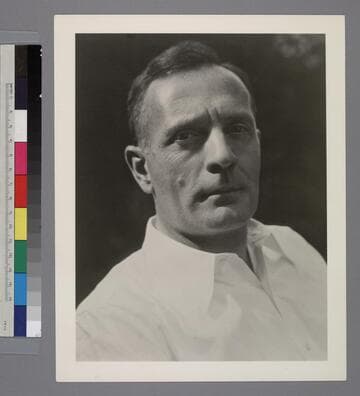 Portrait of Edwin Powell Hubble in a white collared shirt