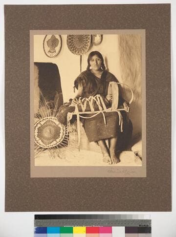 Hopi woman with baby, showing cradle in use among these people