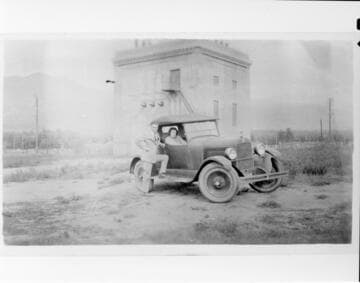 Mr. and Mrs. La Violette in an automobile in front of the City of Los Angeles Sylmar Substation