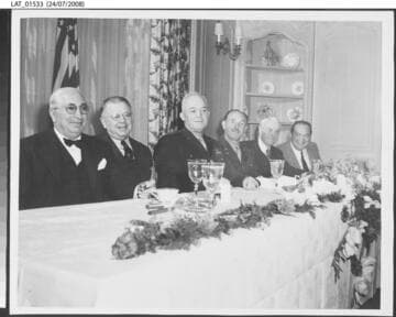 Harry Chandler at dining table with others