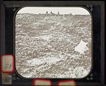 Lava beds with soldiers in distance