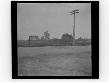 Adobe ruins along a road, "Western Star Soap" advertisement on building at rear