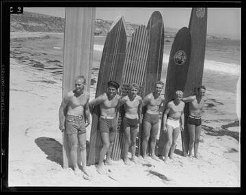 Men with surfboards posing on the beach, Santa Monica