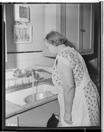 Mrs. _ at sink for fair exhibit