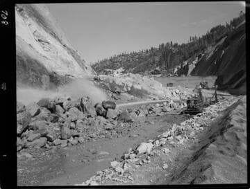 Big Creek - Mammoth Pool - Rock fill placement showing Monitor in operation