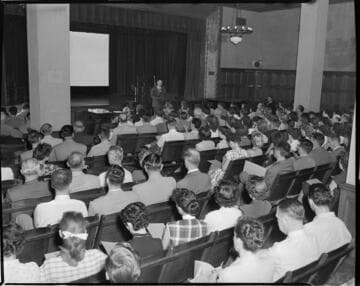 Man speaking at gathering of employees at Edison auditorium