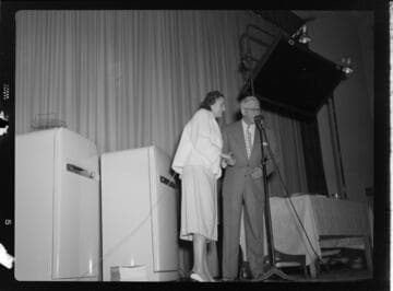 Man and woman on stage for a cooking demonstration
