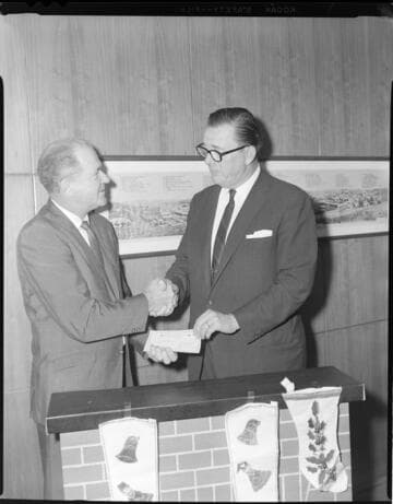 Executives posed exchanging checks