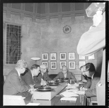 Six men in a meeting