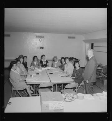 Nine women seated around table in a focus group