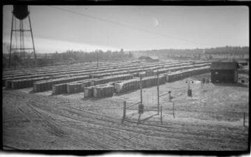 Yard with rows of bailed processed cotton