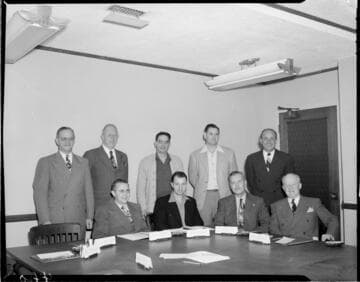 Posed photograph of 9 officers in Edison board room