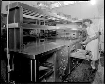 Lady preparing food in unknown commercial kitchen