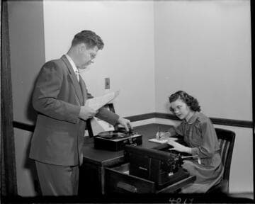 Young lady taking a dictation test from a phonograph record at SCE