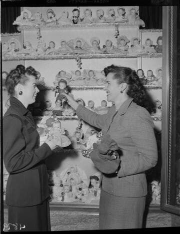 Two ladies with Christmas doll display