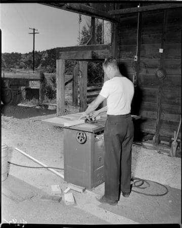 Man cutting wood on a table saw