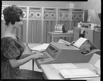 Early computer equipment being used by Edison workers