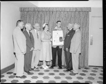 Men presenting and receiving an award