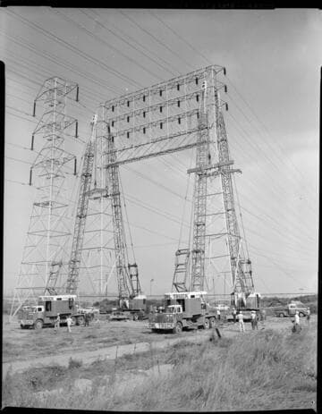 Crew erecting transmission towers