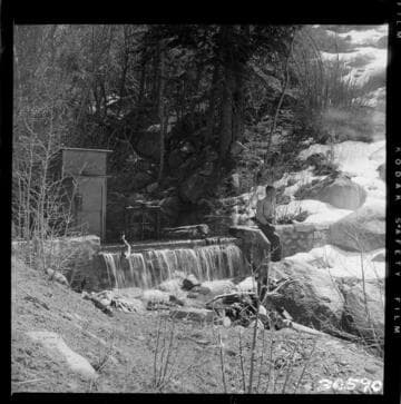 View along Tombstone Creek diversion dam.  Gate is closed and all water is spilling over crest (note