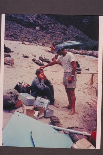 Frank LaRue adjusts the wig of Buzz Belknap; Tapeats Creek