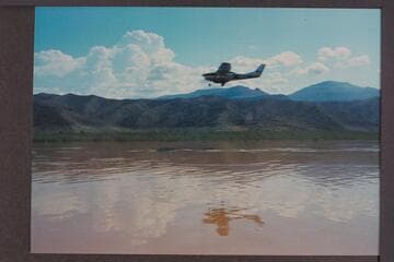 Communication plane to deck boat; Lake Mead above Gods Pocket. Plane runs close to boat