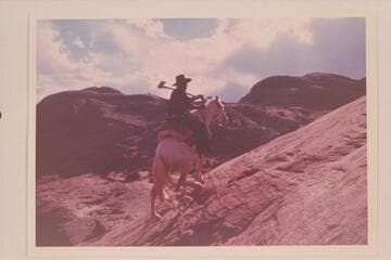 Tobe Owl rides the trail west of Nasja Creek and about opposite its drop-off near the San Juan River