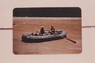 Elgin Pierce and Georgie White in their neoprene raft at Vulcan Rapid on the traverse of the Grand Canyon in 1952, July.  Georgie White handled the oars for the trip