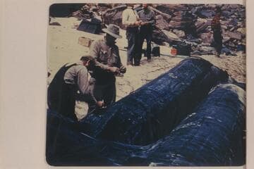 Beginning repairs on the wounded boloney "Millipede." Hatch party traversing Grand Canyon