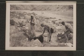 Rod Sanderson and Dock Marston bathe the dishes. Second camp in Marble Canyon. President Harding Rapid. Sanderson; Marston; Beer