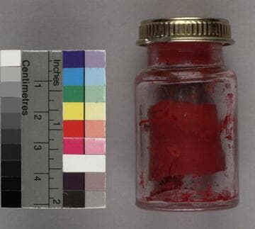 Jar of red tempera paint