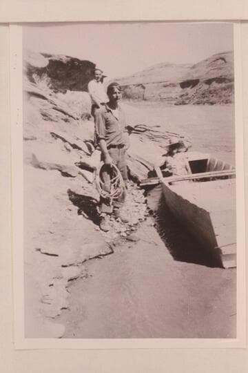 Don Harris and Norm standing on the bank and Aunt Jenny Barton sitting in the boat