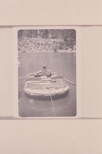William J. Davis in the neoprene raft used for a run of the Yampa River and upper Green River in 1951, June. 55-lb. raft which weighed 75 lbs. when rigged as shown