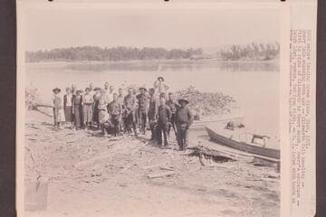 USGS before leaving Green River, Utah, 1921. Emery Kolb standing with oar; Ellsworth Kolb kneeling.To his right, Henry Rauch, Emery's assistant.Leigh Lint, rodman, second from right.E. C. LaRue with hands on hips. Clogston to his left