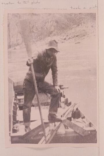 Ray Tankersley standing in the sweep-scow used by the Hyde couple in their effort to traverse the Grand Canyon in 1928. The photograph is at Bright Angel Creek where Tankersley packed supplies for the lower end of the journey