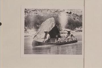 Bishop W. R. McConkie and Wayne McConkie in their canoe below the Junction in Cataract Canyon. Doris Nevills is riding as passenger