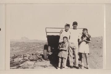 Doris, Norm, Joan and Sandra Nevills; Alhambra Rock and a Cataract boat in background. Near Mexican Hat, Utah